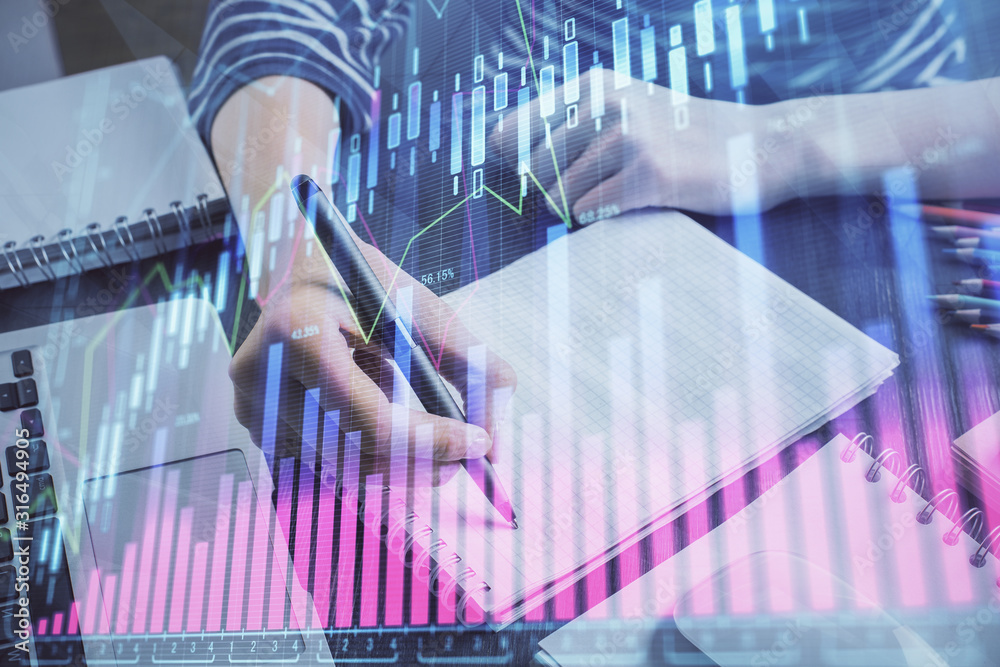 Financial chart drawn over hands taking notes background. Concept of research. Double exposure Financial chart drawn over hands taking notes background. Concept of research. Double exposure
