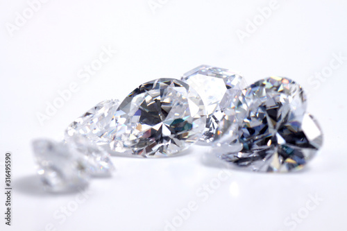 Macro shoots of a group of diamonds that has different shapes, heart, round, pear, asscher, oval, princess, isolated background