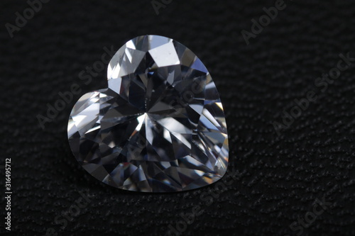 Macro shoot of heart shaped sparkling diamond isolated background