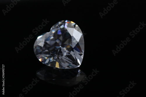 Macro shoot of heart shaped sparkling diamond isolated background