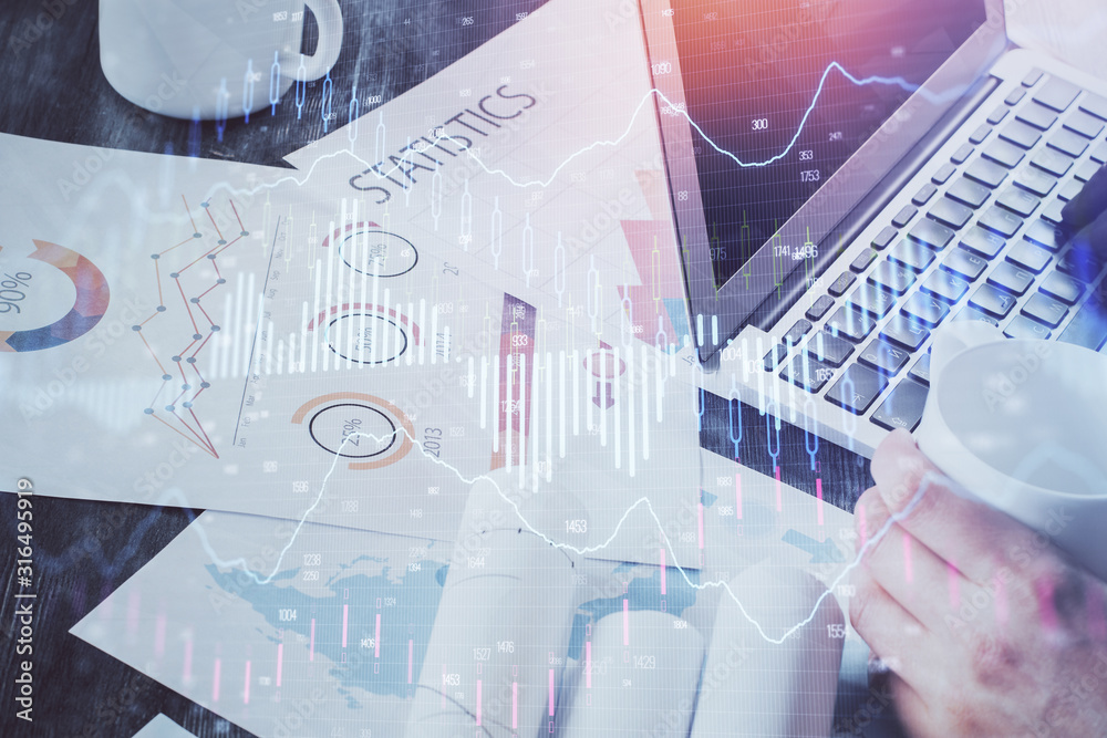Double exposure of stock graph with businessman typing on computer in office on background. Concept of hard work. Double exposure of stock graph with businessman typing on computer in office on background. Concept of hard work.