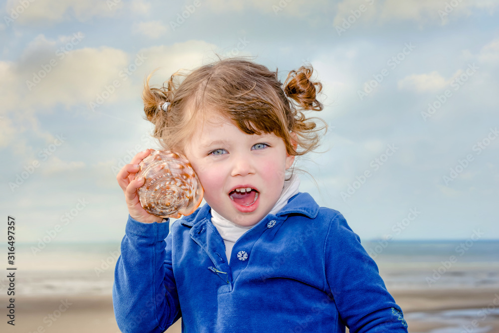 cute little girl on vacation playing with her seashell cute little girl on vacation playing with her seashell
