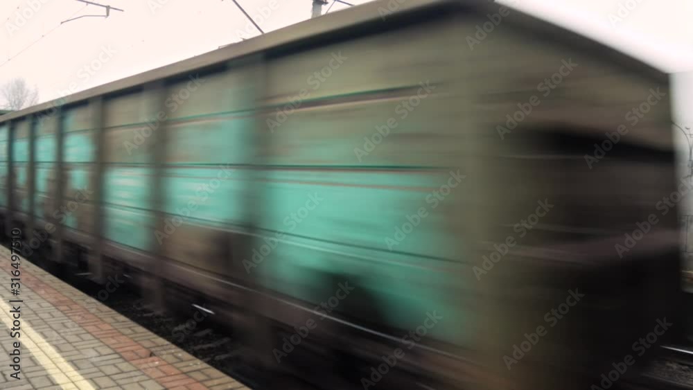 The freight train passes by the station. Wagons with goods delivery. Railway logistics 4k