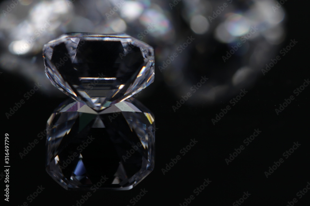 Macro shoots of a group of diamonds that has different shapes, heart, round, pear, asscher, oval, princess, isolated background Macro shoots of a group of diamonds that has different shapes, heart, round, pear, asscher, oval, princess, isolated background