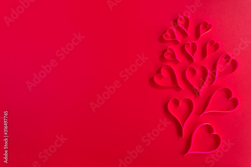 Love and Valentine's day concept., Decoration pink hearts crafts on red background with copy space for text.