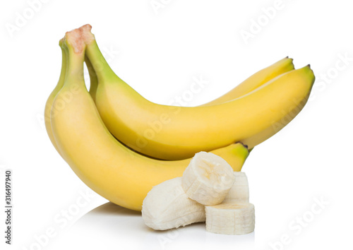 Fresh ripe organic bananas cluster with sliced pieces on white background.