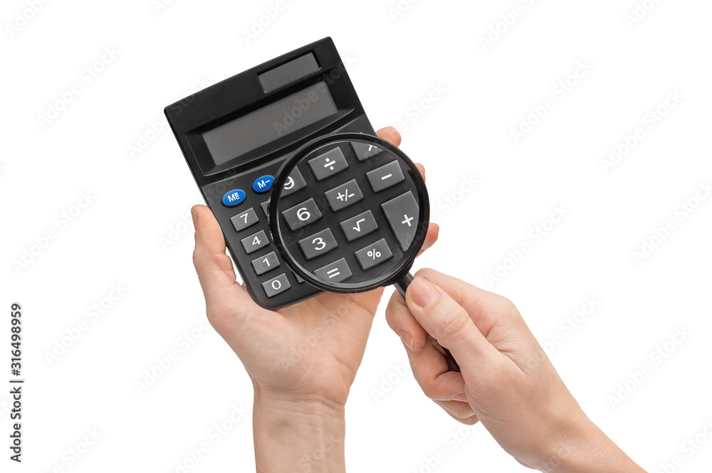 Hand holding magnifying glass over calculator. Isolated white. Hand holding magnifying glass over calculator. Isolated white.