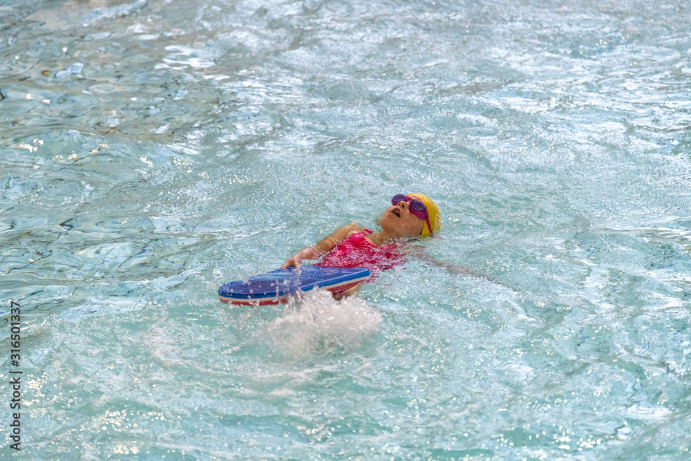 little girl swimming in a pool