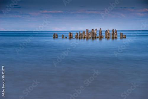 Old harbor ruins. Blue sea and port. Harbour in Baltic sea, Latvia, Europe © Artenex