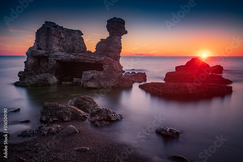 Fototapeta Naklejka Na Ścianę i Meble -  Liepaja beach bunker. Brick house, soft water, waves and rocks. Abandoned military ruins facilities in a stormy sea. Barracks building in the Baltic sea. Liepaja, Latvia, Europe.
