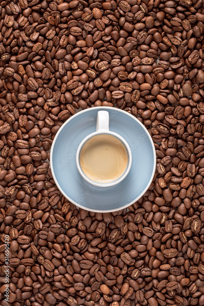 Espresso cup top view and coffee beans as background Espresso cup top view and coffee beans as background
