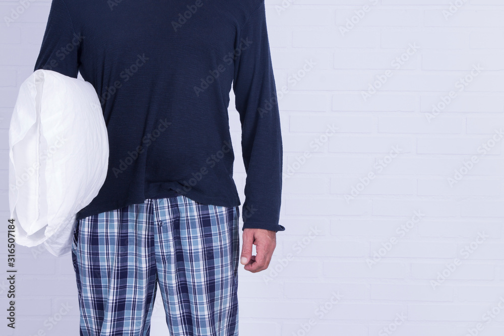 man in pajamas with pillow in hands man in pajamas with pillow in hands