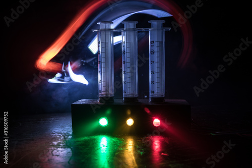 Prisoner handcuffed to death by lethal injection, vial with sodium thiopental and syringe on top of a table, conceptual image photo