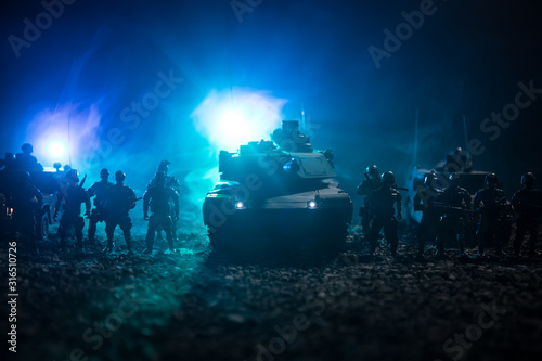 Military patrol car on sunset background. Army war concept. Silhouette of armored vehicle with soldiers ready to attack. Artwork decoration. Selective focus