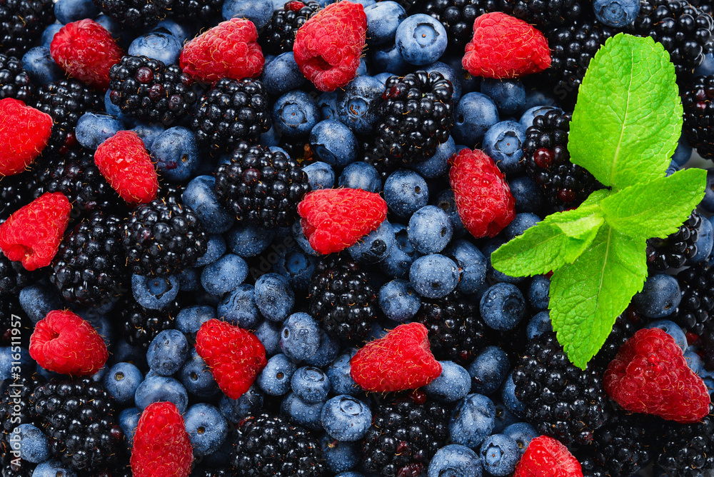 Blackberry, raspberry, blueberry and mint background. Blackberry, raspberry, blueberry and mint background.