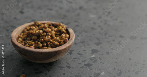 dried seaberry in olive bowl on terrazzo countertop