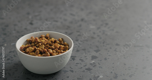 dried seaberry in white bowl on terrazzo countertop