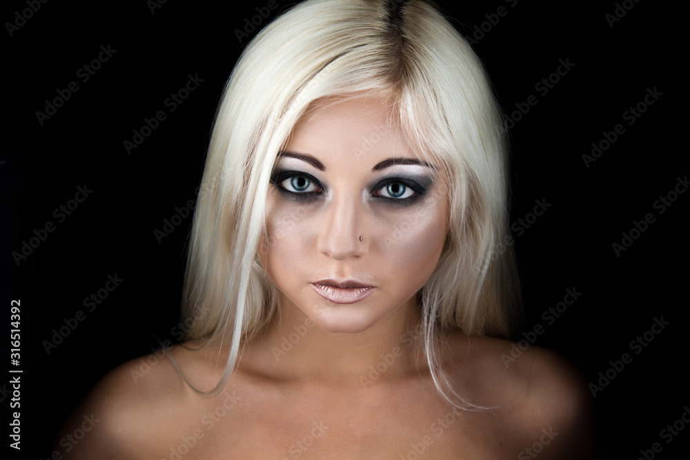 Young blonde woman face with dark makeup Young blonde woman face with dark makeup