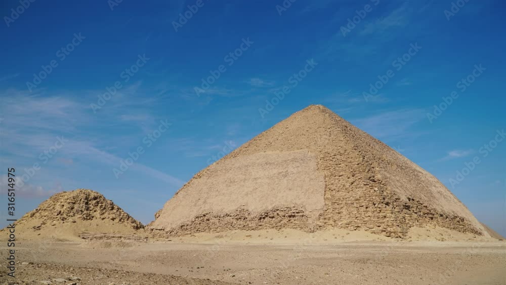 The Bent Pyramid is an ancient Egyptian pyramid located at the royal necropolis of Dahshur, approximately 40 kilometres south of Cairo, built under the Old Kingdom Pharaoh Sneferu. Egypt