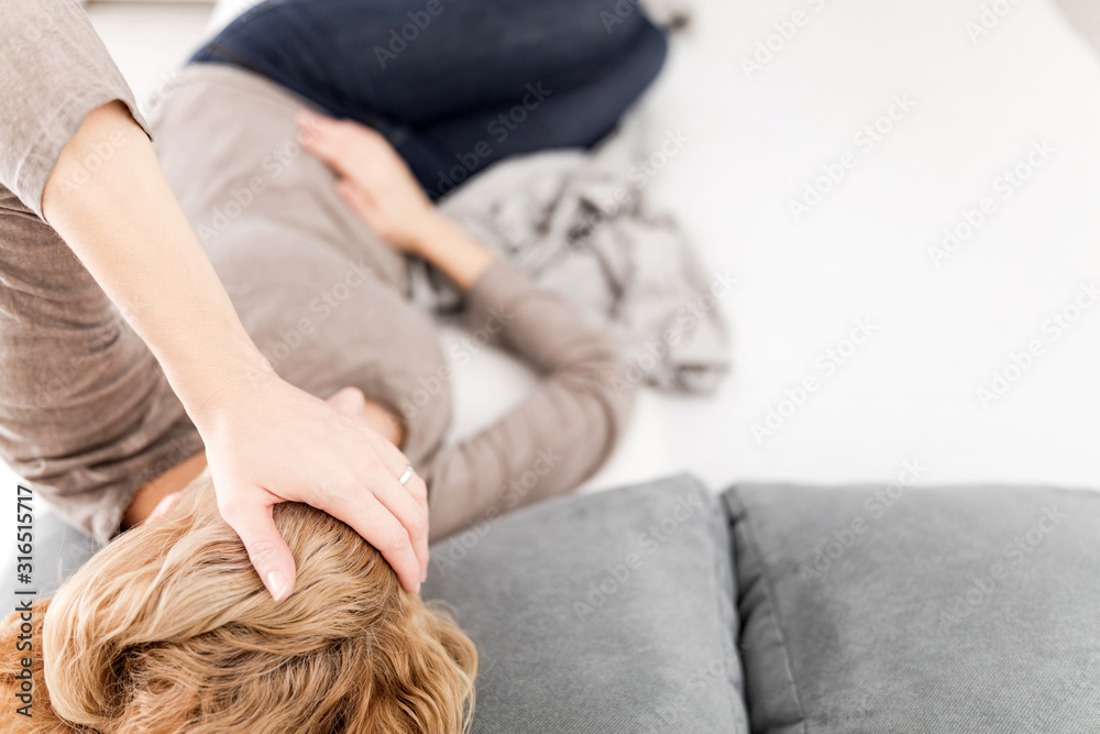 Tired exhausted woman with stomach issues at home on a couch, being sick, pregnant. Tired exhausted woman with stomach issues at home on a couch, being sick, pregnant.