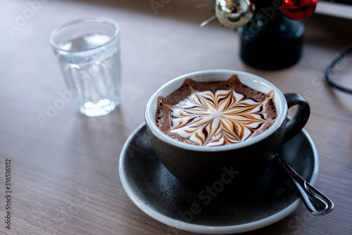 hot coffee on table in cafe, latte art,flower latte art, camera, background