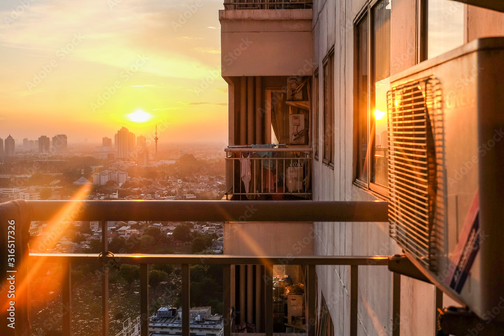 View of sunset in Jakarta from an apartment's balcony
