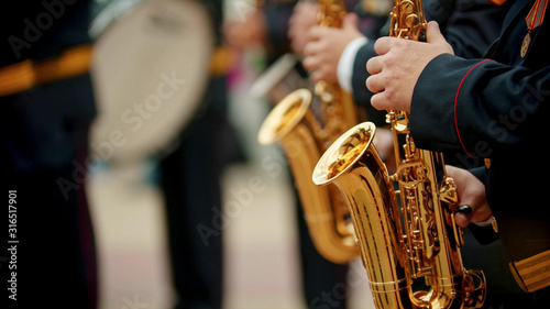 A man plays the saxophone. jazz musician in a white shirt plays the trumpet. closeup shot of a gold saxophone held by a musician