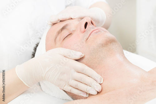 Man in the mask cosmetic procedure in spa salon 