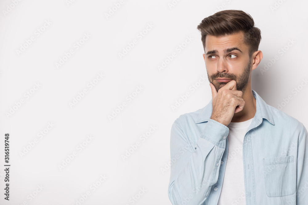 Pensive young guy looking aside at empty copy space. Pensive young guy looking aside at empty copy space.