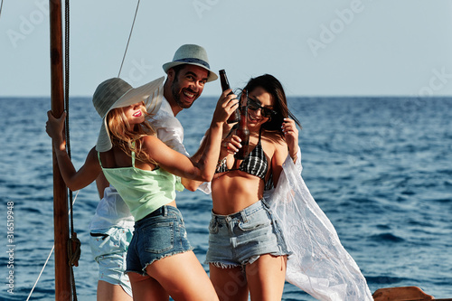 a group of young people having fun in a boat - summer concept © alvaro