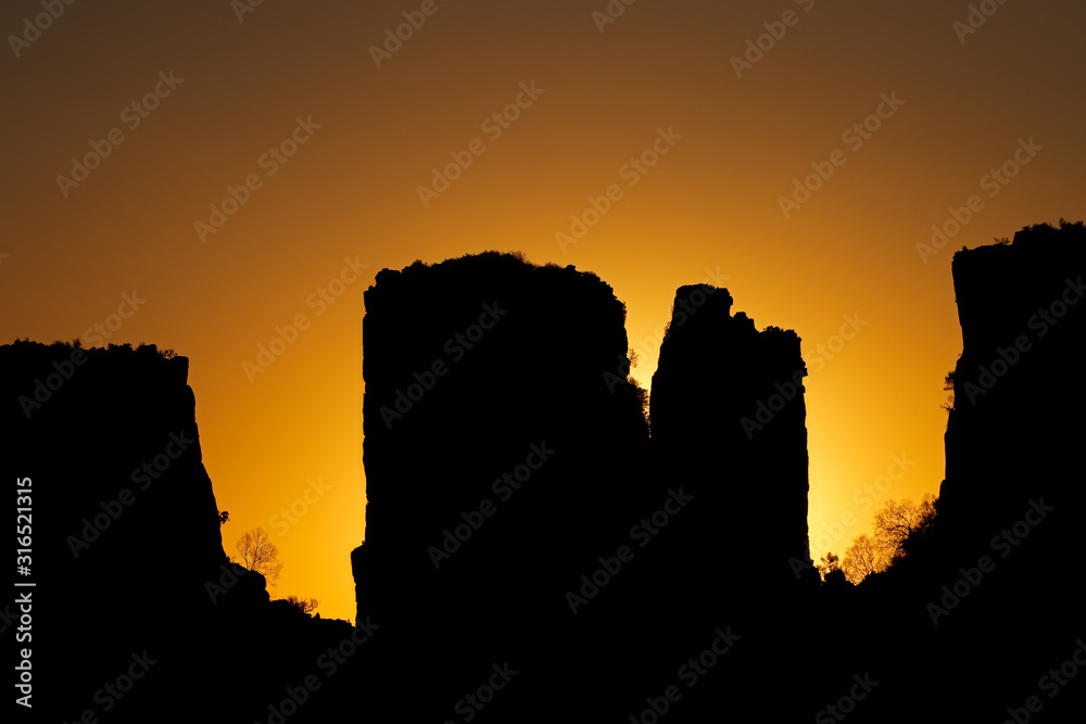 Obraz premium Rock silhouettes at sunset, Valley of desolation, Camdeboo National Park, South Africa.