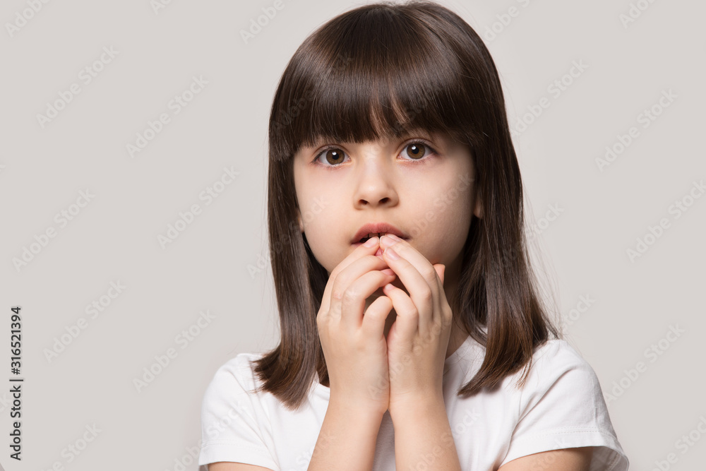 Worried about left alone little girl holding hands near mouth. Worried about left alone little girl holding hands near mouth.