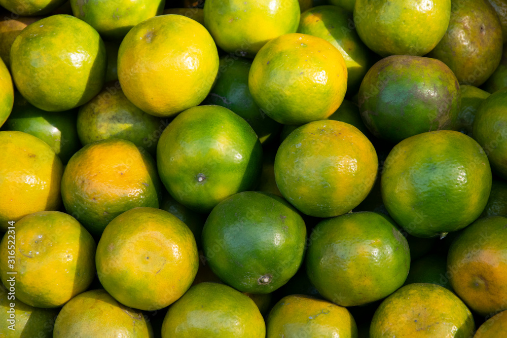 Tangerine oranges Green and orange for sale in the colorful fruit market. Tangerine oranges Green and orange for sale in the colorful fruit market.