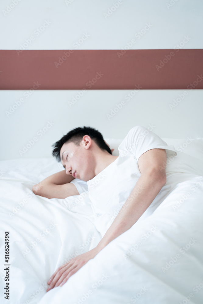 side view of bearded man sleeping on bed, lying on side side view of bearded man sleeping on bed, lying on side