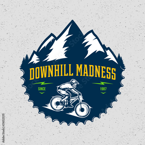 Vector downhill mountain biking badge, logo, label with rider on a bike and mountain silhouette. Downhill, enduro, cross-country biking illustration