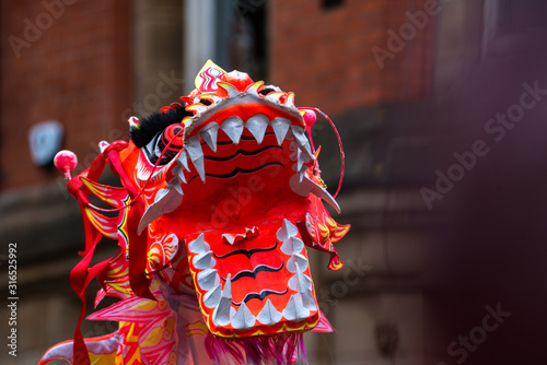 Dancing Dragon in Chinese New Year Festival fun puppet people parade festival celebration uk manchester red