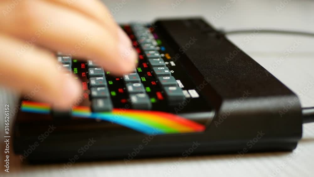 Man's hand typing on an old computer