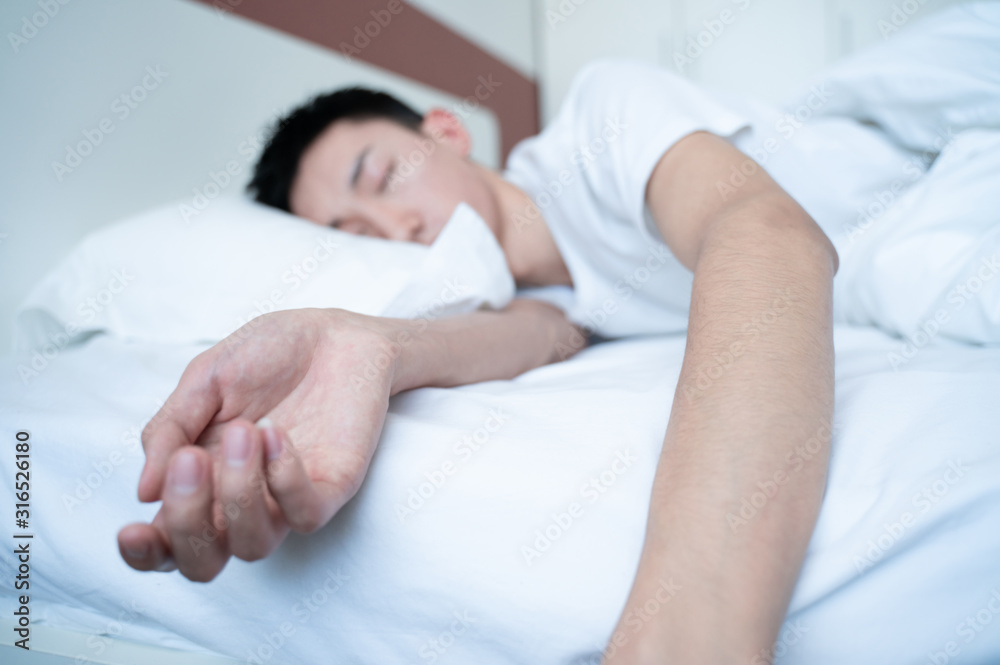 side view of bearded man sleeping on bed, lying on side side view of bearded man sleeping on bed, lying on side