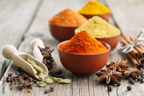 Aromatic spices and herbs: red pepper, turmeric, cardamom, cinnamon, cloves, anise, paprika. Ingredients for cooking. Ayurveda treatments photo