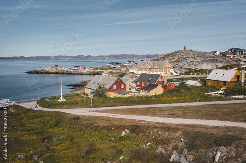 Nuuk city of Hans Egede. Capital of Greenland. Colorful inuit houses in a suburb of arctic capital Nuuk. The old hospital - school at the waterfront of Nuuk, Greenland. photo