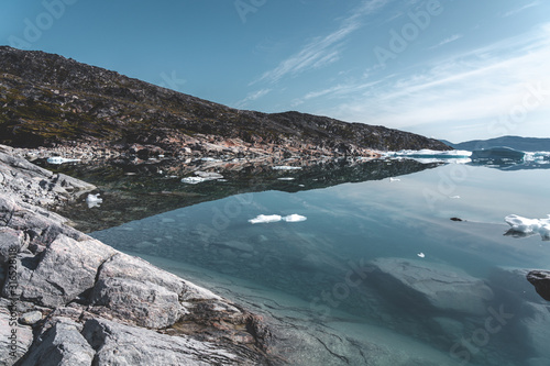 Beautifull landscape with floating icebergs in glacier lagoon and lake in Greenland. Ilulissat Icefjord Glacier. Iceberg and ice from glacier in arctic nature landscape.