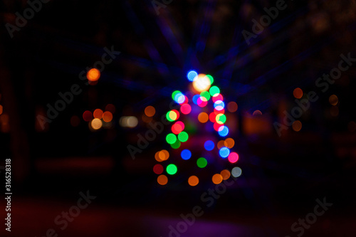 Christmas abstract blur background. Christmas tree with defocused lights. Bokeh.