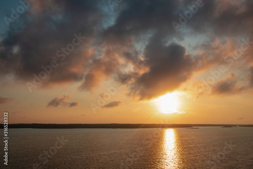Landscape with sunset on Baltic Sea. View of waves and beautiful sunset sky with clouds from the side of ferry. Seascape