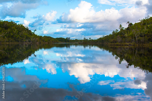 Clouds mirroring in lake in pangalanes madagascar/ pristine african water landscape