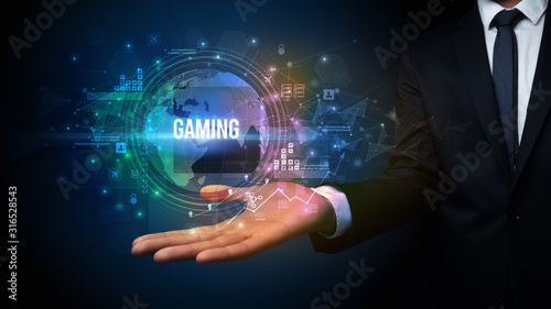 Elegant hand holding GAMING inscription, digital technology concept