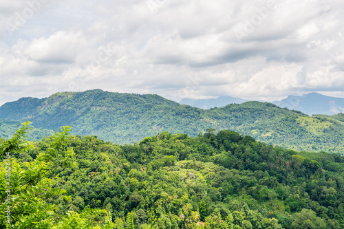 Landscape of mountain and green rainforest under sunlight near Kandy, Sri Lanka.