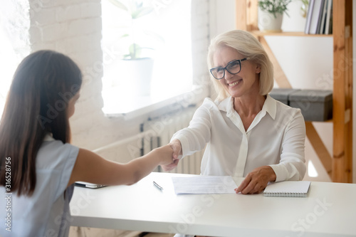 Female hr manager shaking hands with female job applicant