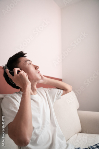 Asian Young Man Listening Music On Headphone, Indoors