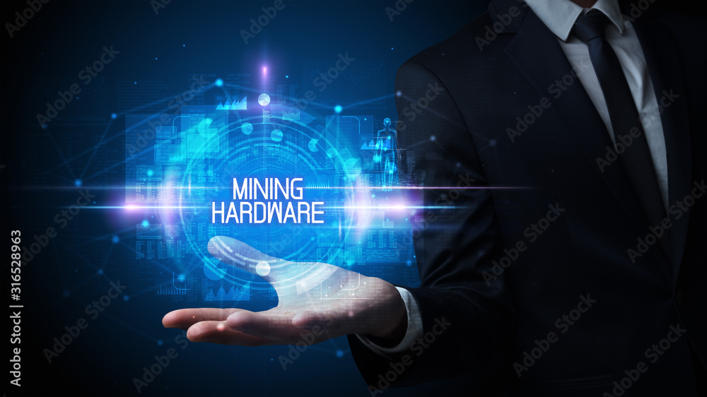Man hand holding MINING HARDWARE inscription, technology concept Man hand holding MINING HARDWARE inscription, technology concept