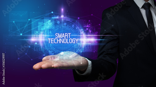 Man hand holding SMART TECHNOLOGY inscription, technology concept